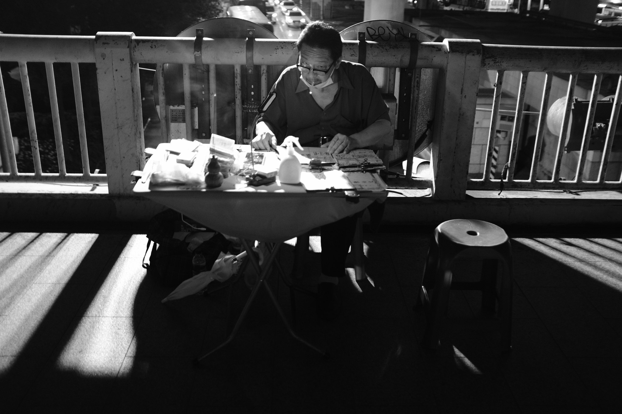 Unposed black and white street photograph of a local resident framed by Taiwan's urban edges